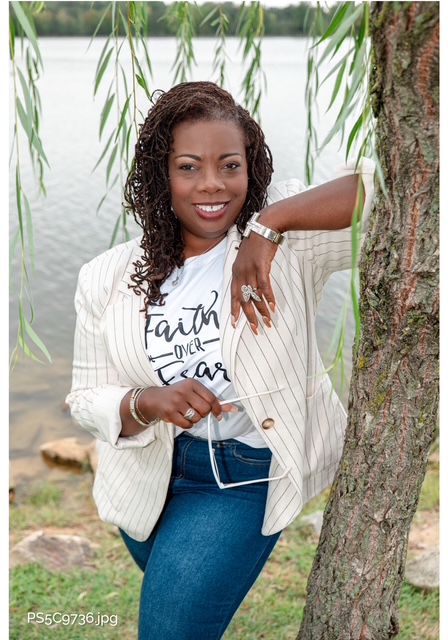 Minister Rose CiConta, founder of SELAH, standing by the water under a willow tree